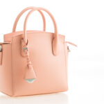 Beautiful elegance and luxury fashion leather pink women handbag isolated on white background